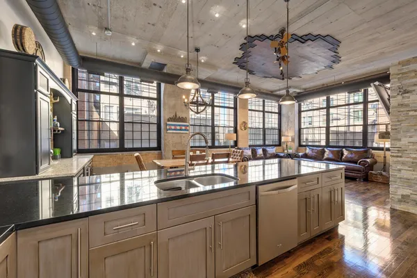 a large kitchen with a large window and stainless steel appliances