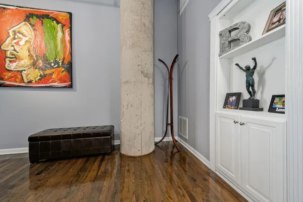 a view of a hallway with wooden floor and closet