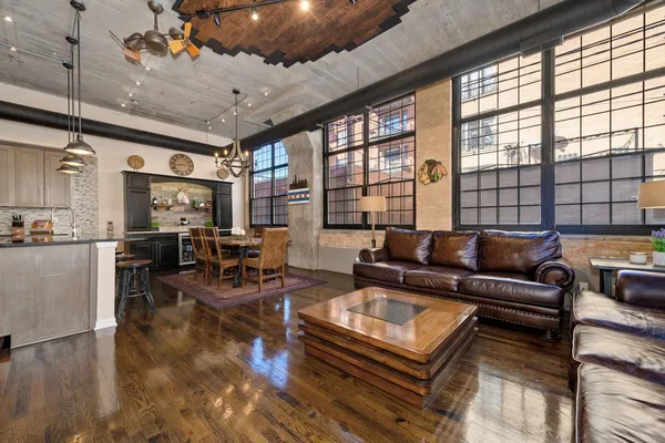a living room with furniture and large windows