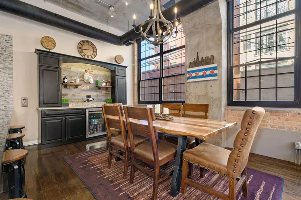 a dining room with furniture and a large window