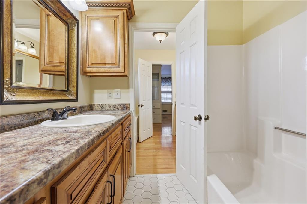2224 Colonial Drive Gainesville, GA 30501 - Photo 19 of 40 a bathroom with a granite countertop sink and a mirror