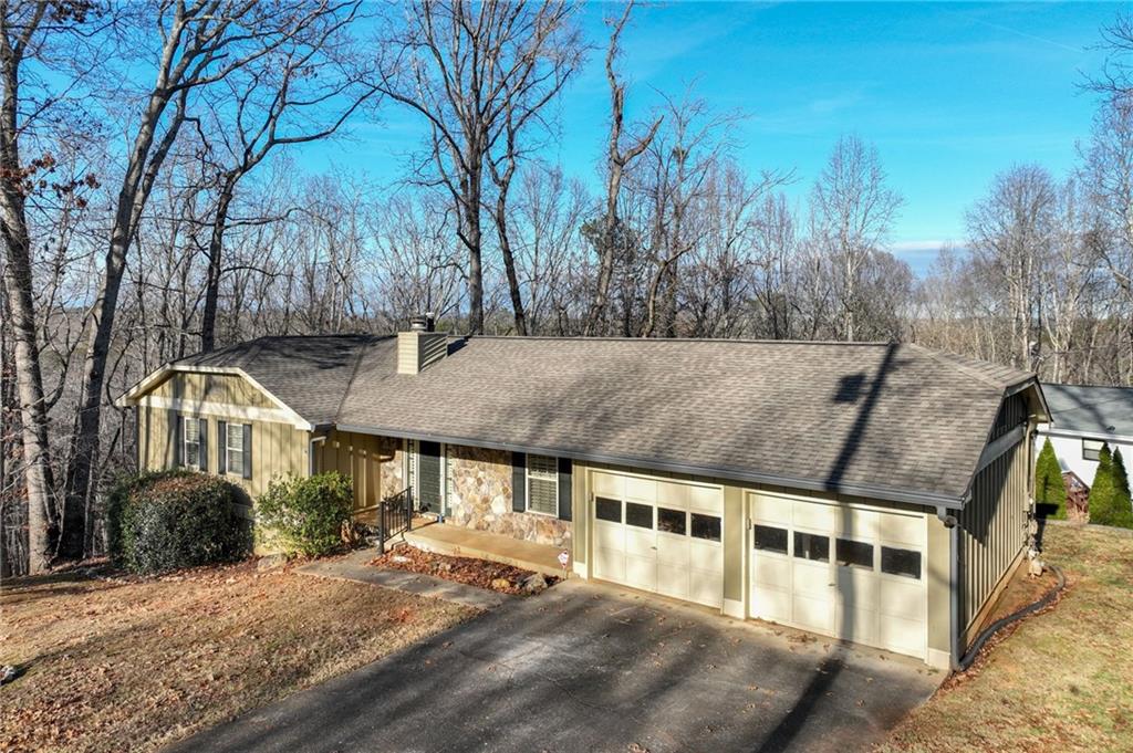 2224 Colonial Drive Gainesville, GA 30501 - Photo 7 of 40 a view of a large white house with a yard and large tree