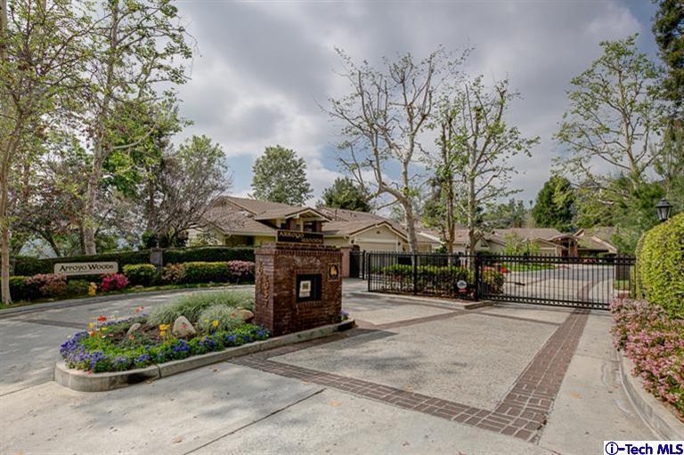 a front view of a house with a yard and a garden