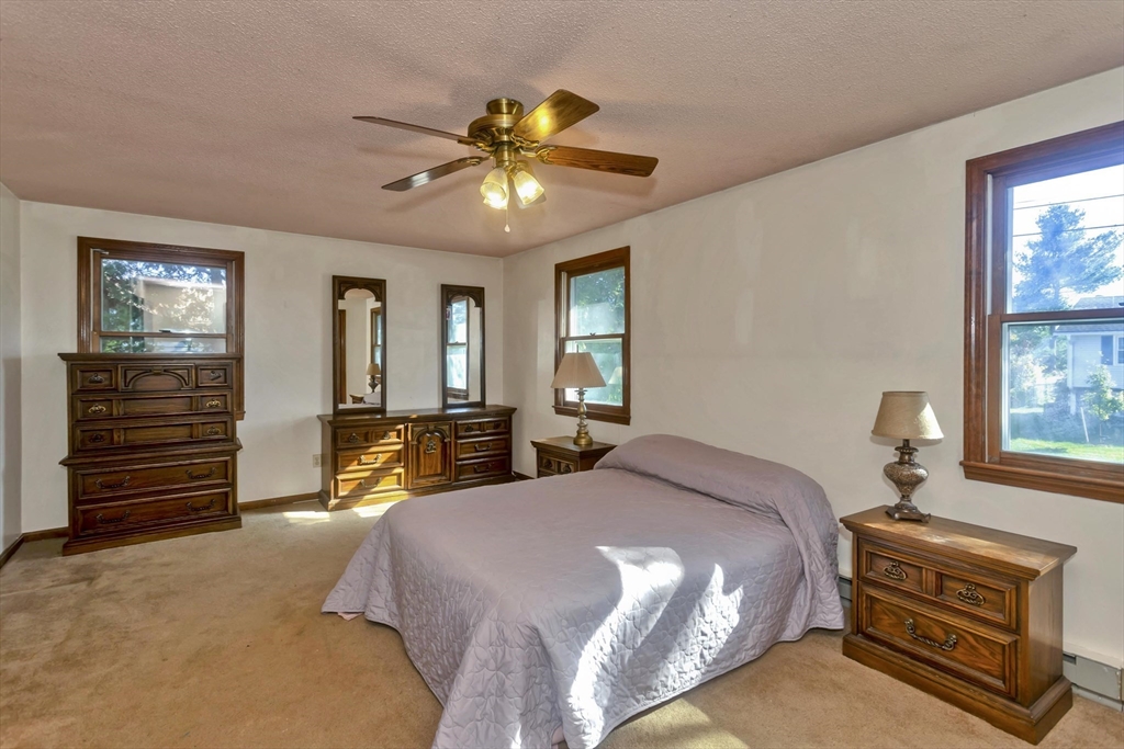 212 Poplar Street Chicopee, MA 01013 - Photo 12 of 22 a bedroom with a bed and a chandelier