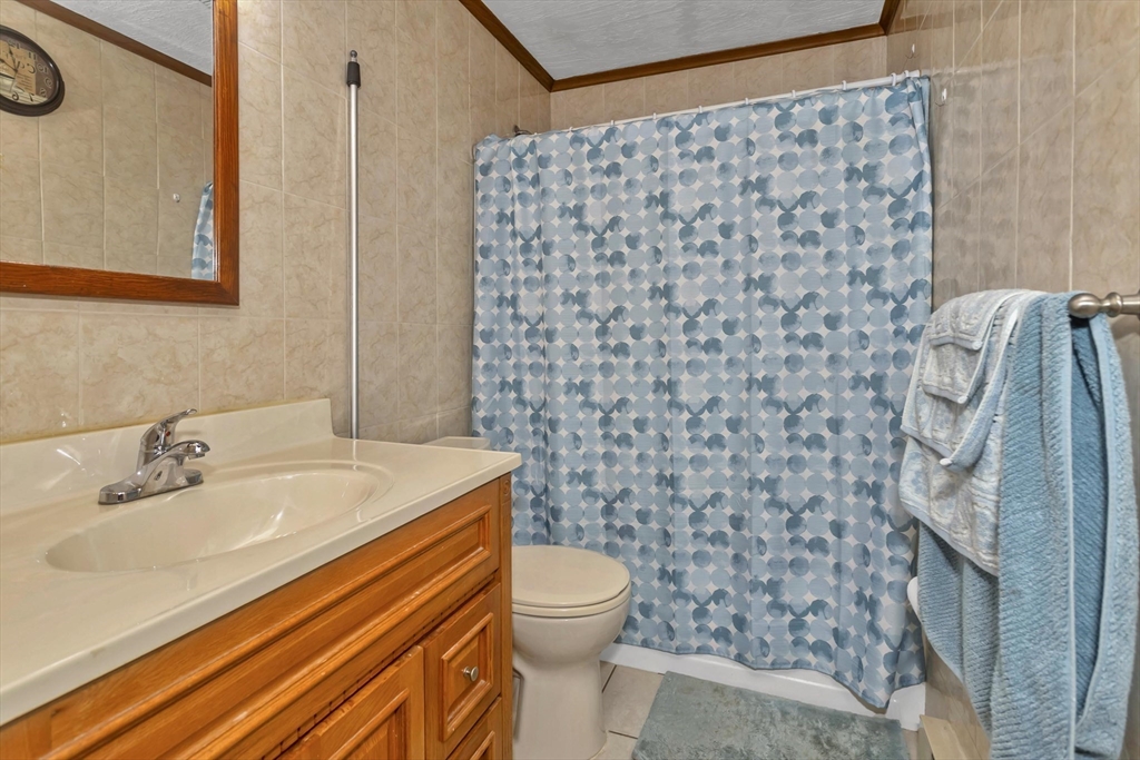 212 Poplar Street Chicopee, MA 01013 - Photo 13 of 22 a bathroom with a sink toilet and shower