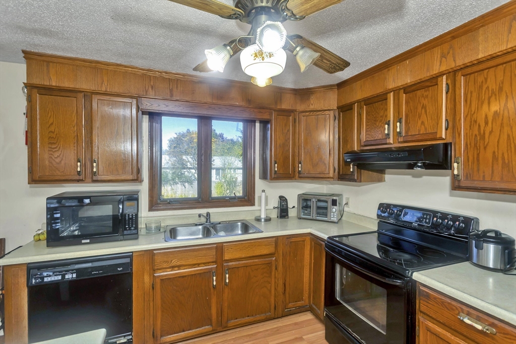 212 Poplar Street Chicopee, MA 01013 - Photo 2 of 22 a kitchen with stainless steel appliances granite countertop a sink stove and cabinets