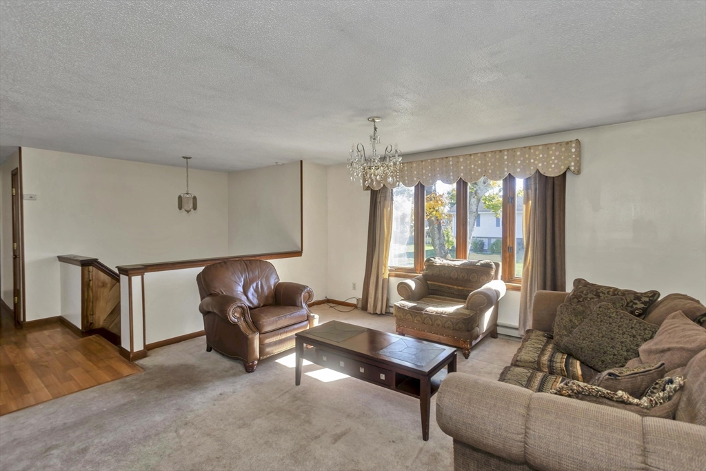 212 Poplar Street Chicopee, MA 01013 - Photo 7 of 22 a living room with furniture and a window