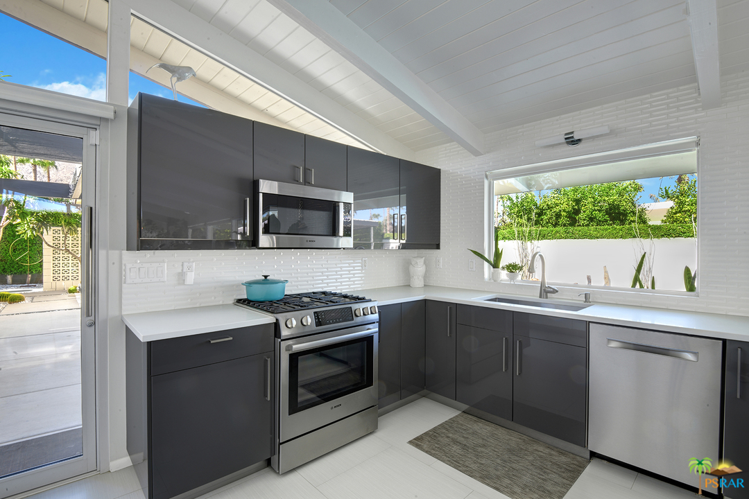984 East La Jolla Road Palm Springs, CA 92264 - Photo 14 of 53 a kitchen with a sink stove and microwave
