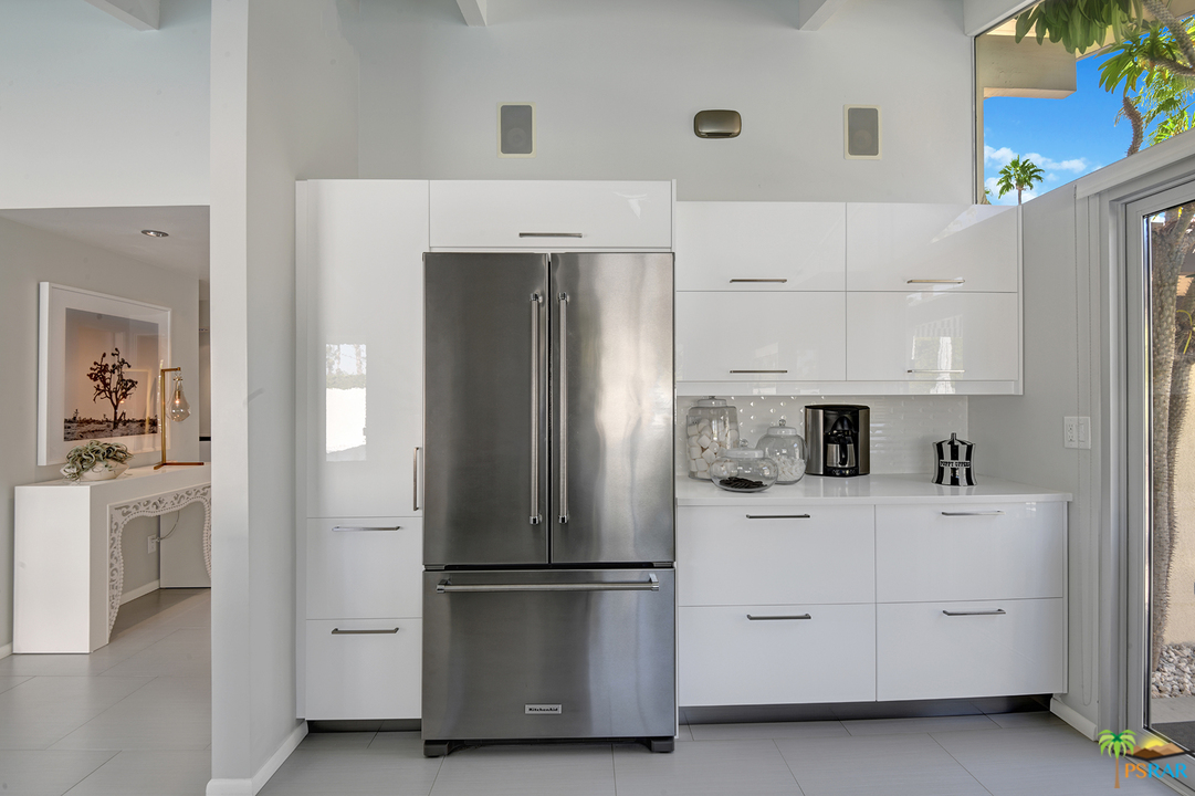 984 East La Jolla Road Palm Springs, CA 92264 - Photo 15 of 53 a kitchen with white cabinets and white appliances