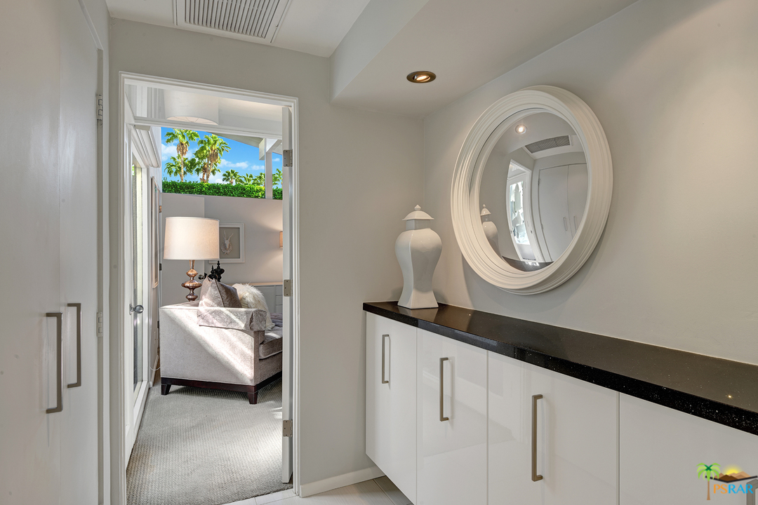984 East La Jolla Road Palm Springs, CA 92264 - Photo 17 of 53 a en suite bathroom with a granite countertop double vanity sink and a mirror