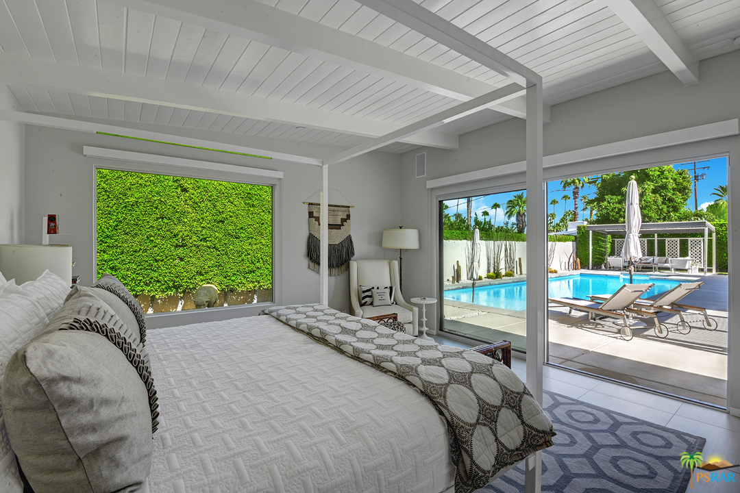 984 East La Jolla Road Palm Springs, CA 92264 - Photo 32 of 53 a bedroom with a bed and large windows