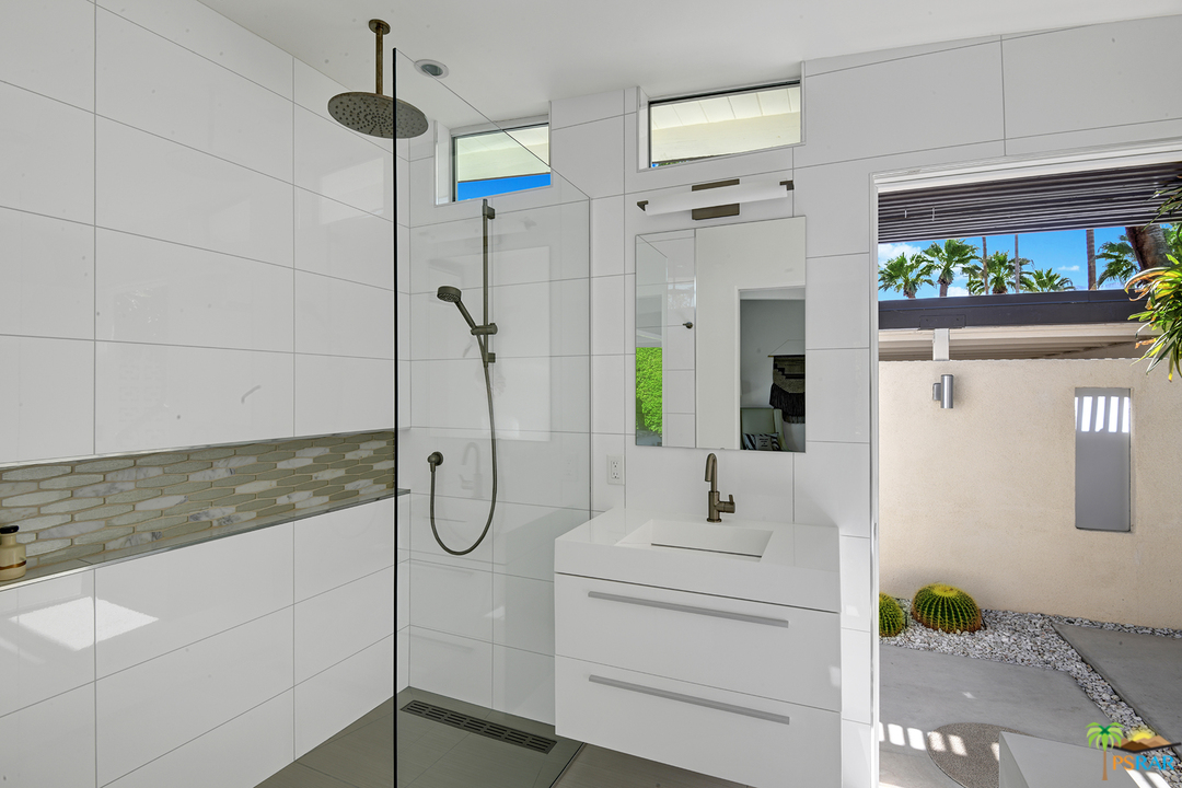 984 East La Jolla Road Palm Springs, CA 92264 - Photo 36 of 53 a bathroom with a shower sink and mirror
