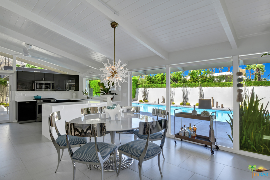 984 East La Jolla Road Palm Springs, CA 92264 - Photo 7 of 53 a view of a dining room and livingroom with furniture wooden floor a chandelier