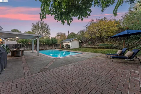a front view of a house with a garden and yard