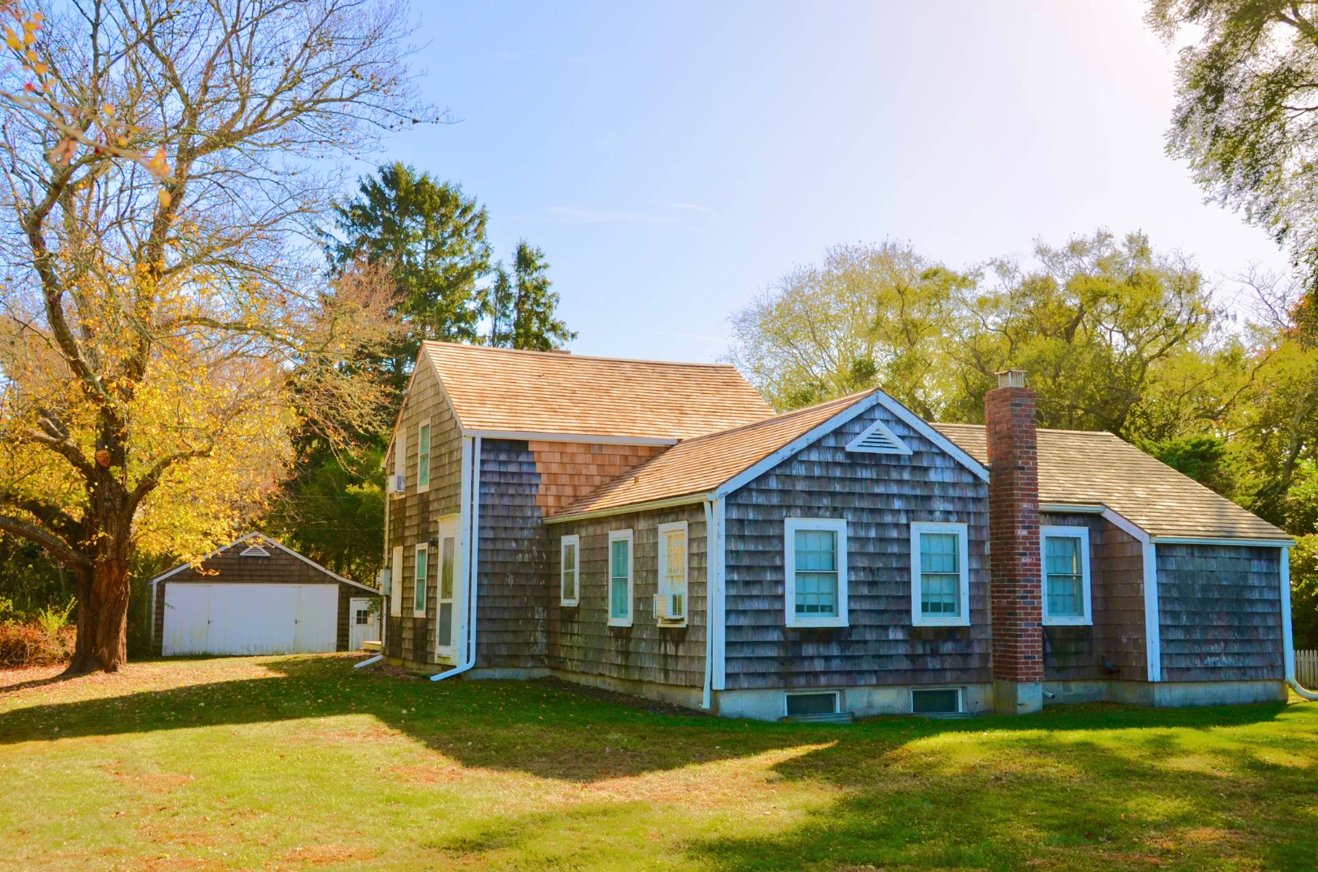 328 Town Line Road Sagaponack, NY 11962 - Photo 1 of 25 a view of a yard in front of a house with a large tree