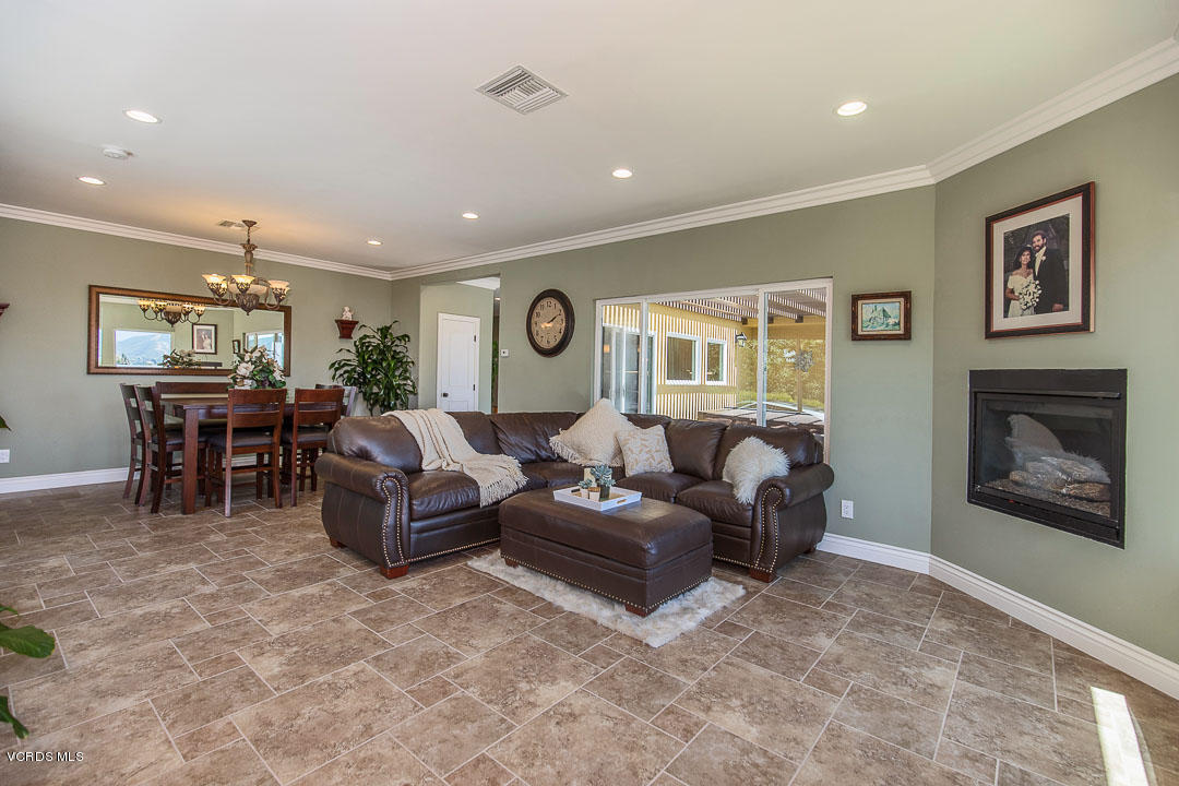 959 Rancho Road Thousand Oaks, CA 91362 - Photo 12 of 57 a living room with furniture a large window and a fireplace