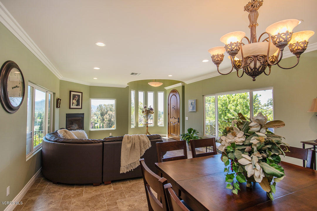 959 Rancho Road Thousand Oaks, CA 91362 - Photo 14 of 57 a view of a dining room with furniture a chandelier and large windows