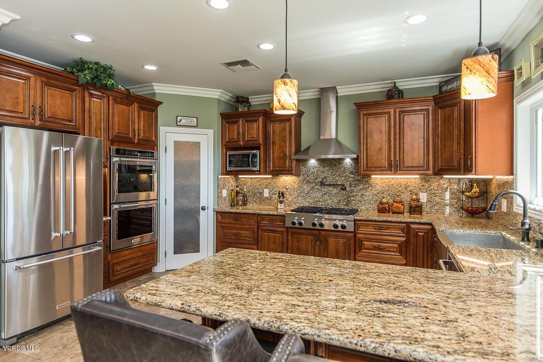 959 Rancho Road Thousand Oaks, CA 91362 - Photo 21 of 57 a kitchen with stainless steel appliances granite countertop a sink refrigerator and cabinets