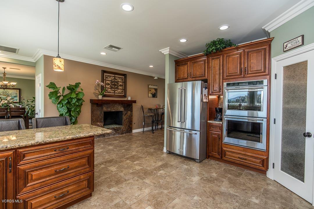 959 Rancho Road Thousand Oaks, CA 91362 - Photo 24 of 57 a kitchen with granite countertop a refrigerator and a stove