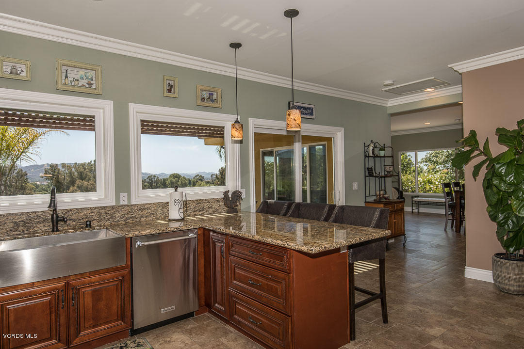 959 Rancho Road Thousand Oaks, CA 91362 - Photo 26 of 57 a open kitchen with granite countertop a sink and a table