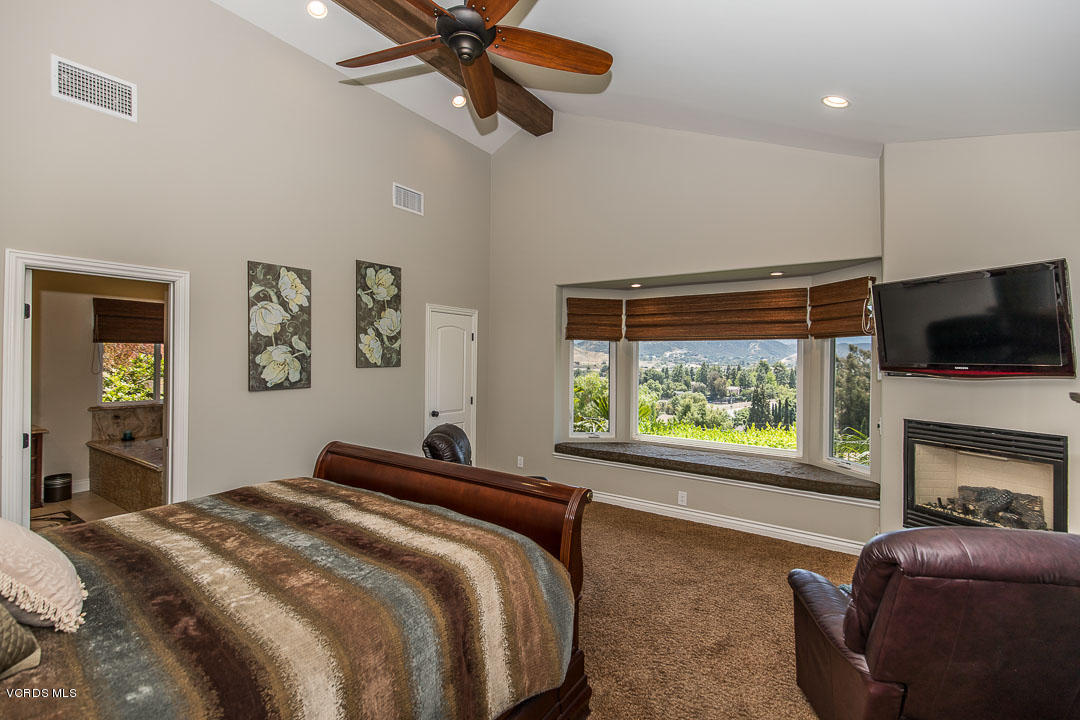 959 Rancho Road Thousand Oaks, CA 91362 - Photo 28 of 57 a bedroom with a bed and a flat screen tv