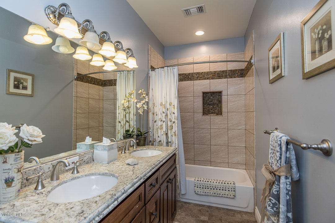 959 Rancho Road Thousand Oaks, CA 91362 - Photo 33 of 57 a bathroom with a granite countertop sink a large mirror and a shower