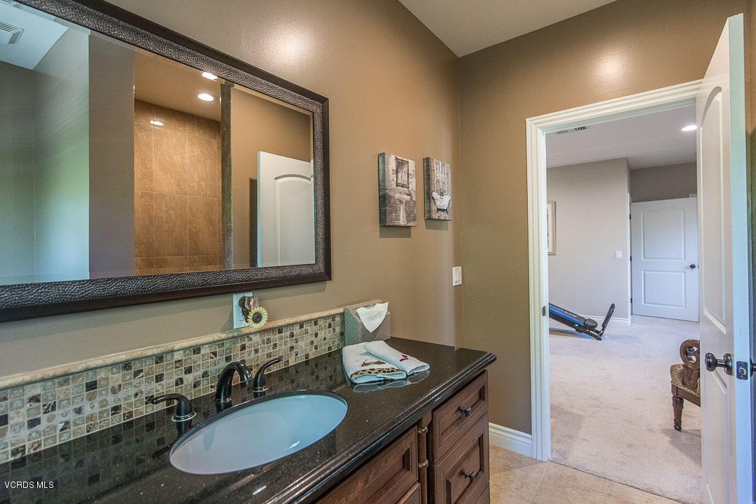959 Rancho Road Thousand Oaks, CA 91362 - Photo 36 of 57 a bathroom with a granite countertop sink and a mirror