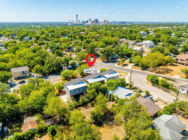 an aerial view of residential houses with outdoor space