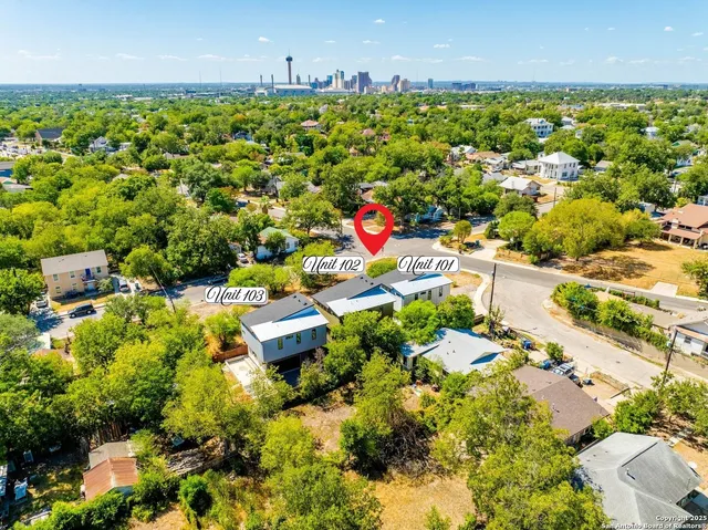 an aerial view of residential houses with outdoor space