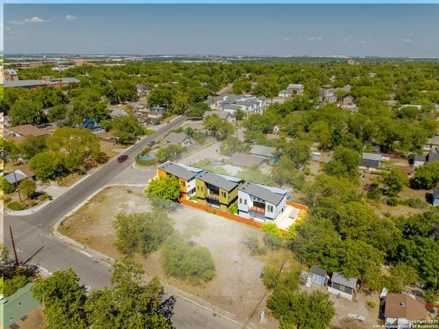 an aerial view of residential houses with outdoor space