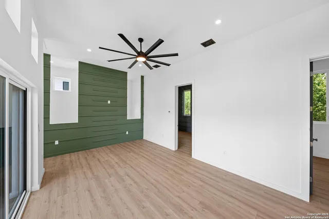 a view of a big room with wooden floor and cabinet