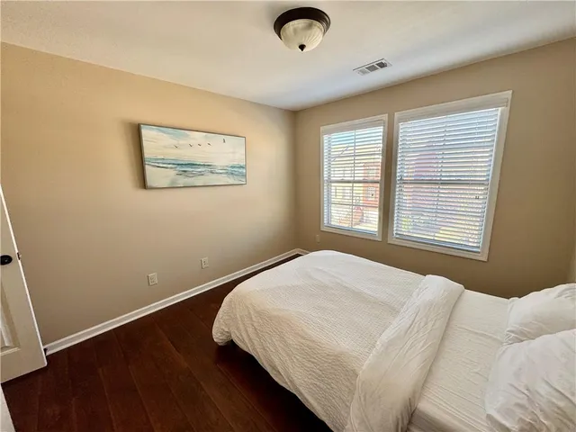a bed sitting in a bedroom next to a window