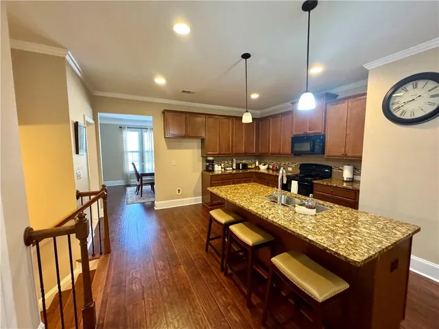 a kitchen with a table chairs refrigerator and microwave
