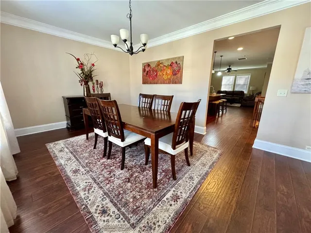 a view of a dining room with furniture wooden floor and a chandelier