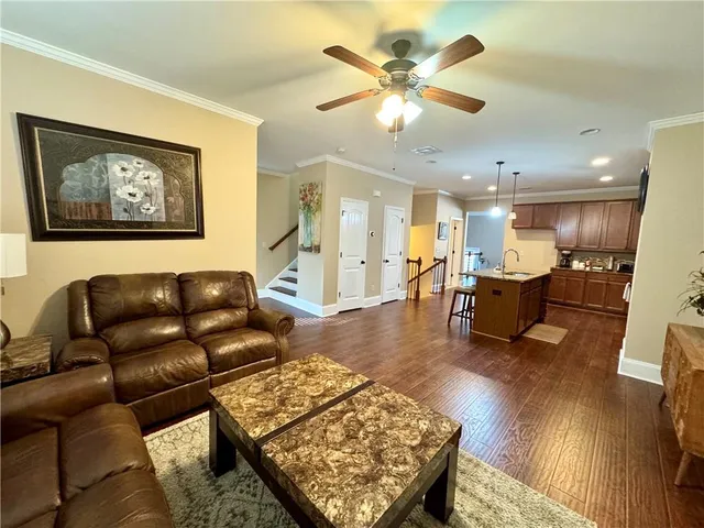 a living room with furniture and kitchen view