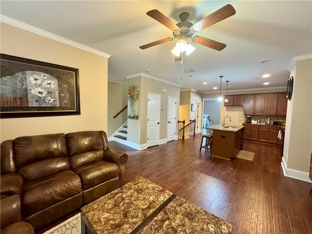 a living room with furniture or kitchen view and a wooden floor