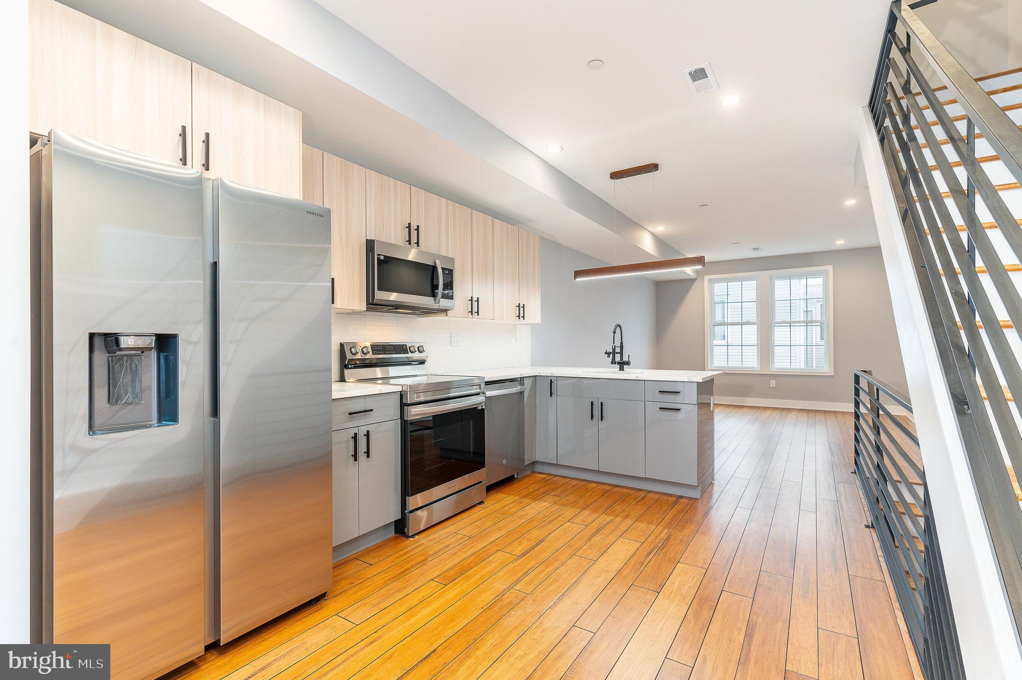 2821 Livingston Street, Unit 2 Philadelphia, PA 19134 - Photo 1 of 24 a large kitchen with a refrigerator a stove top oven a sink and dishwasher
