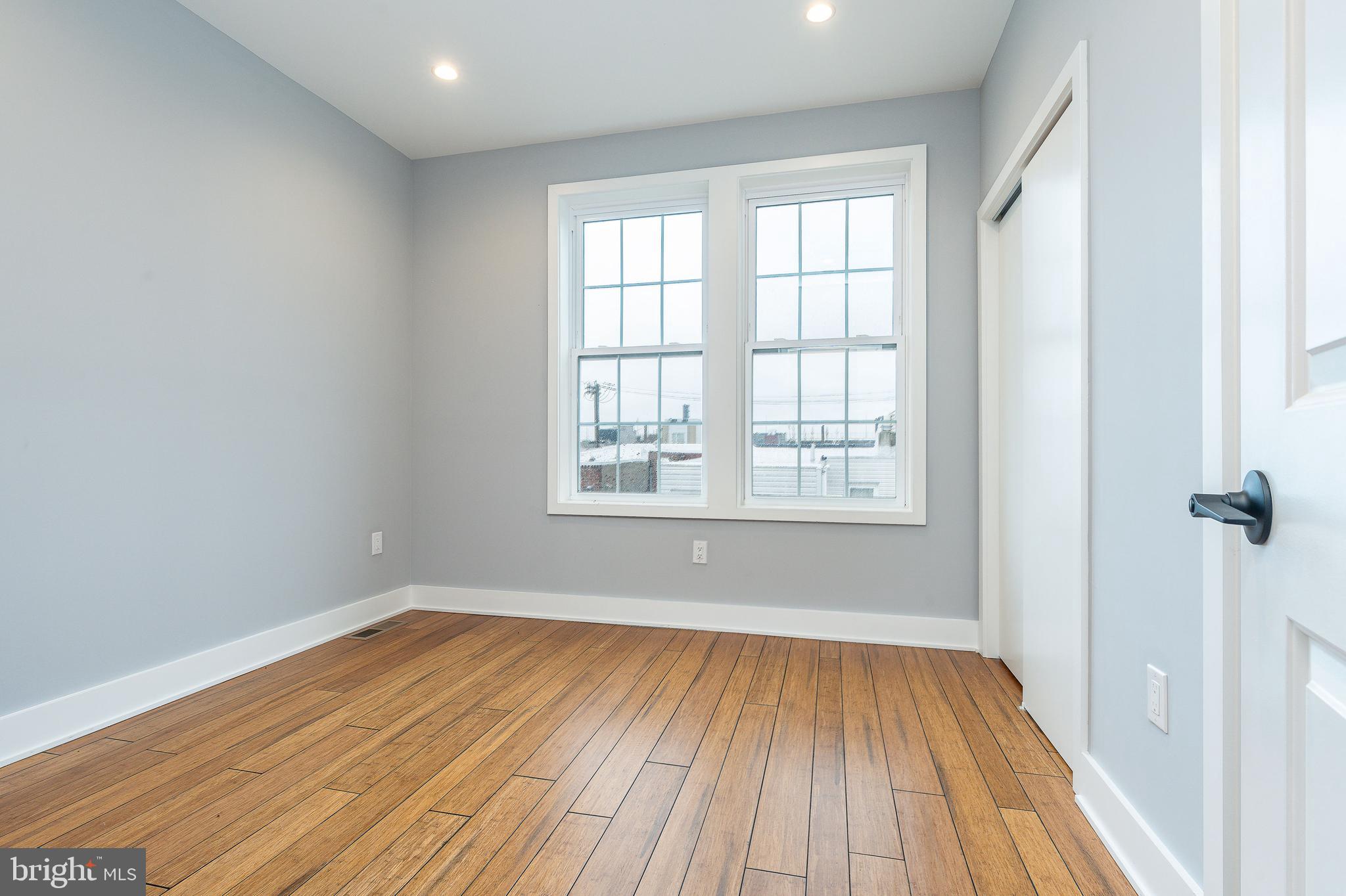 2821 Livingston Street, Unit 2 Philadelphia, PA 19134 - Photo 12 of 24 wooden floor in an empty room with a window