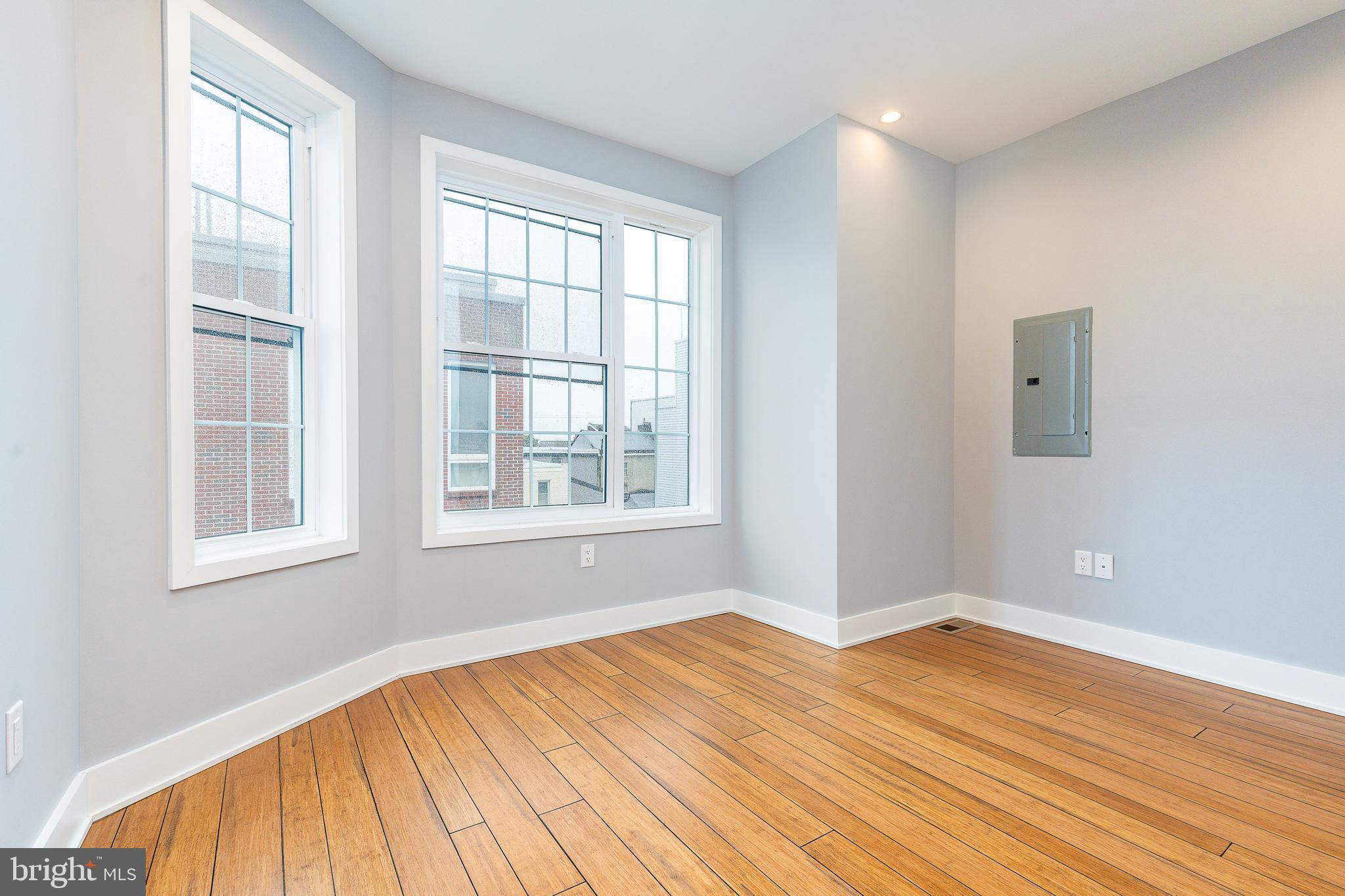 2821 Livingston Street, Unit 2 Philadelphia, PA 19134 - Photo 17 of 24 an empty room with wooden floor and windows