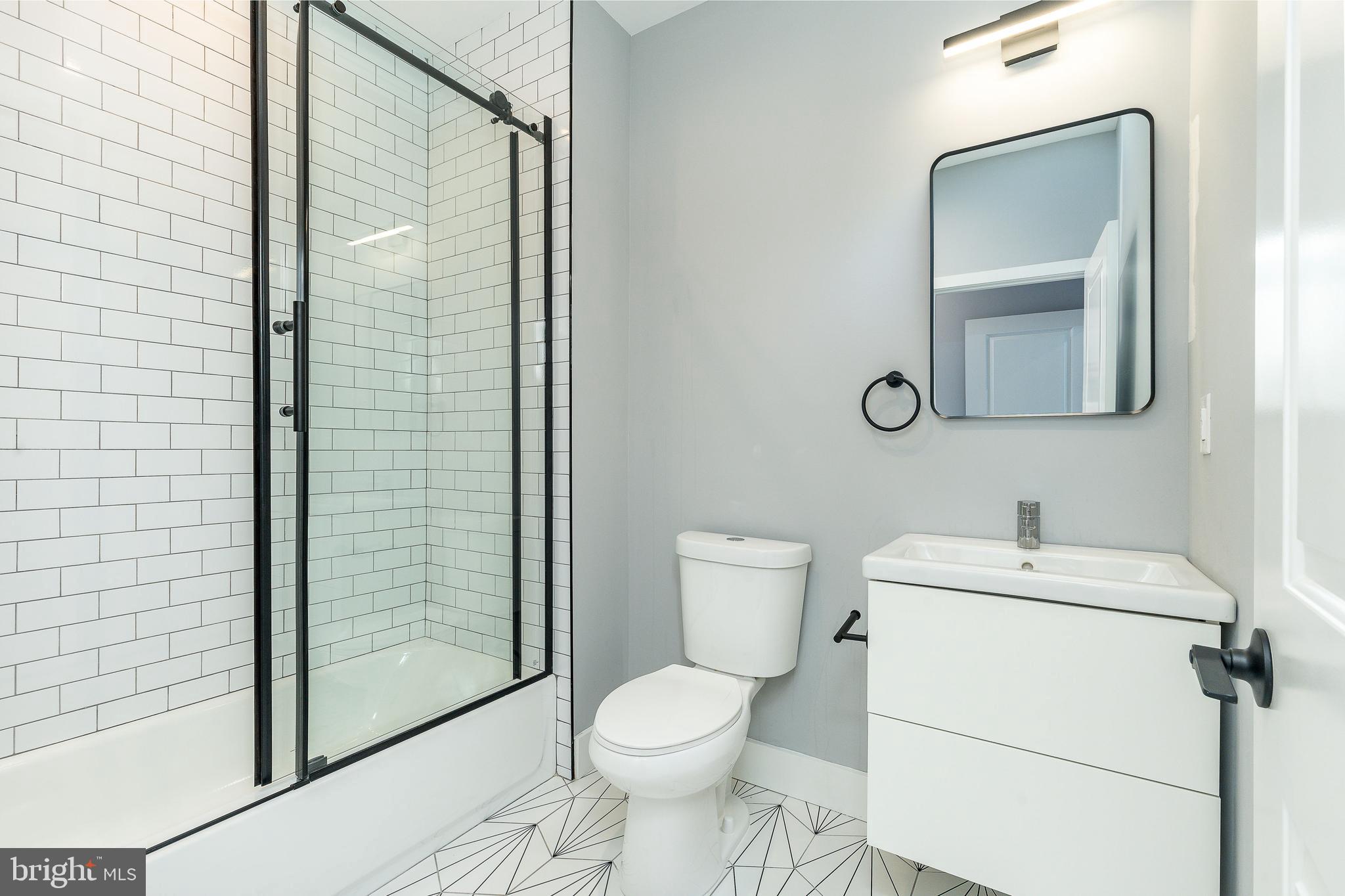 2821 Livingston Street, Unit 2 Philadelphia, PA 19134 - Photo 19 of 24 a white toilet sitting next to a bathroom sink