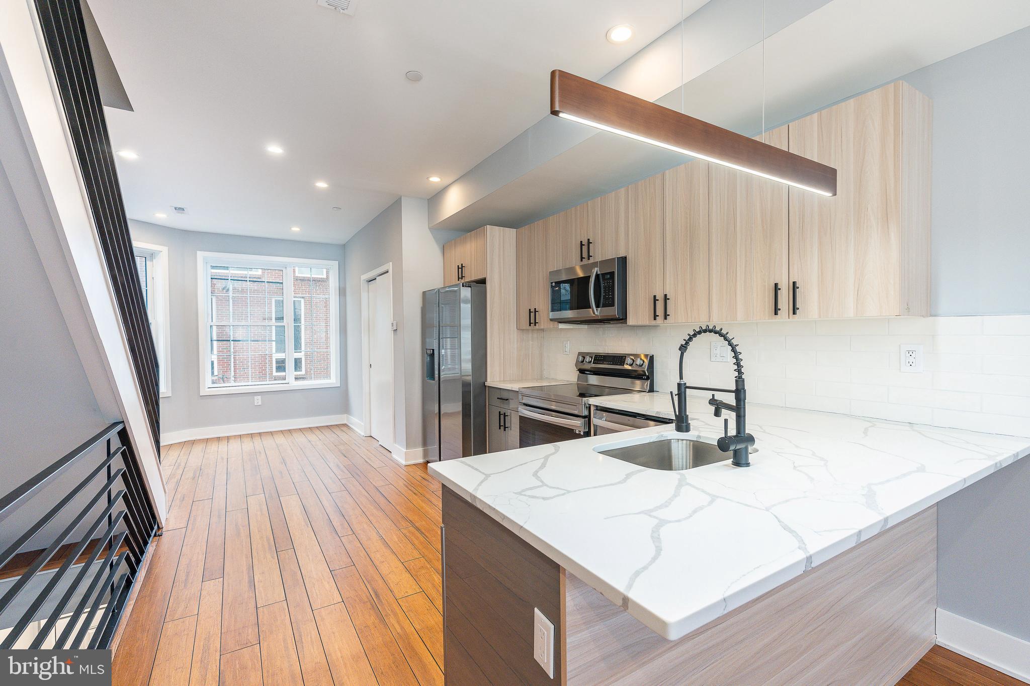 2821 Livingston Street, Unit 2 Philadelphia, PA 19134 - Photo 6 of 24 a kitchen with sink a refrigerator and microwave