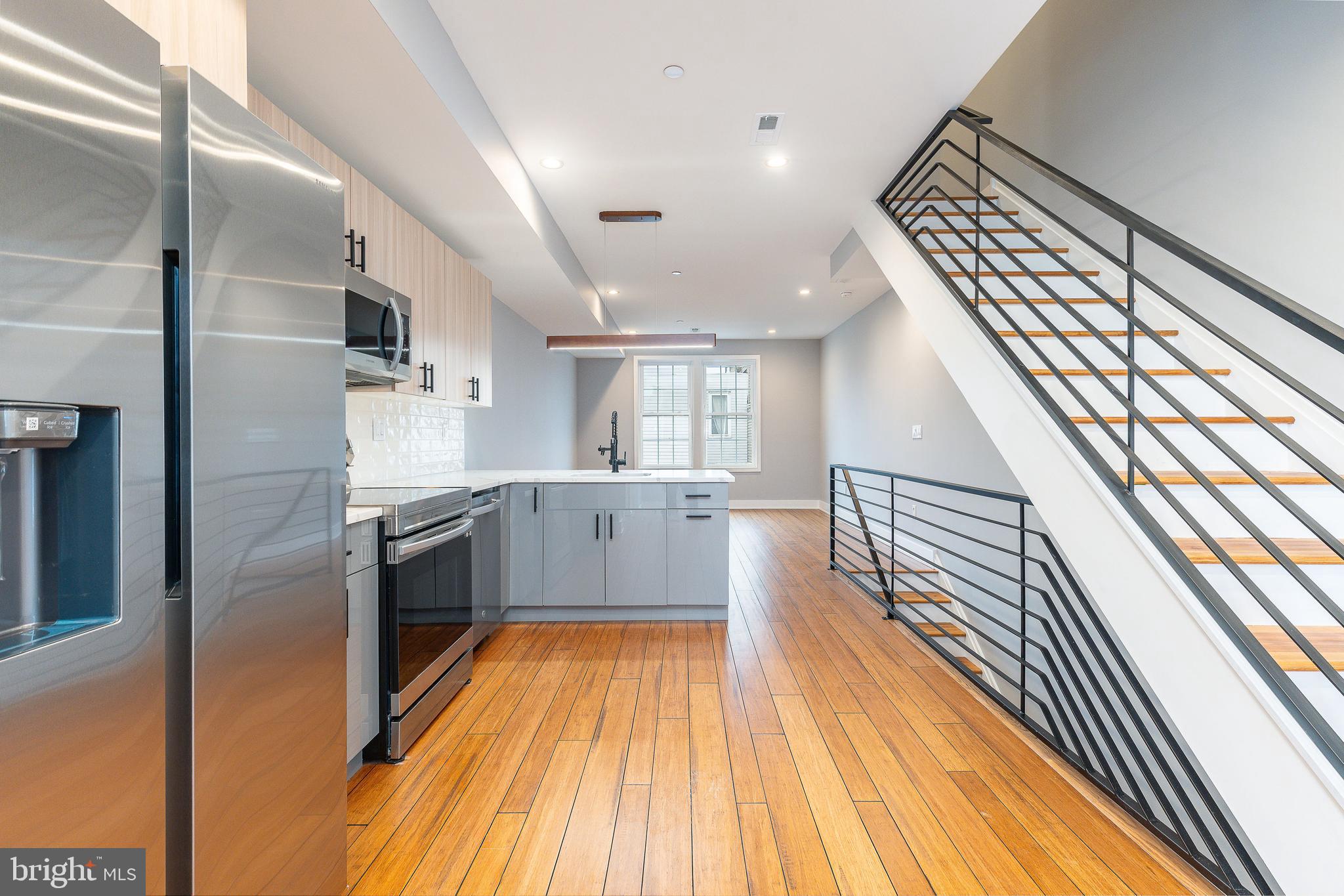 2821 Livingston Street, Unit 2 Philadelphia, PA 19134 - Photo 8 of 24 a kitchen with stainless steel appliances a sink and wooden floor
