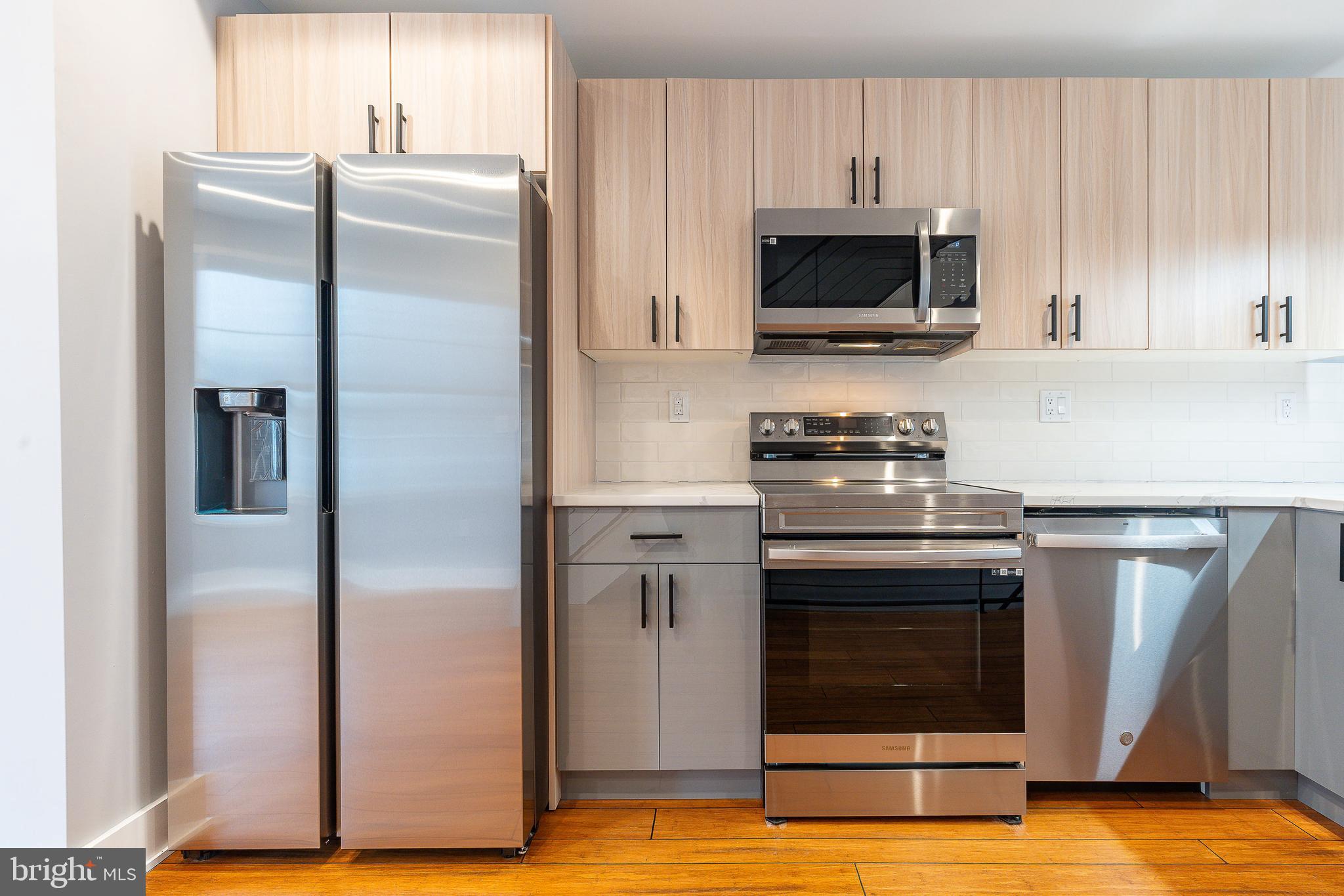 2821 Livingston Street, Unit 2 Philadelphia, PA 19134 - Photo 9 of 24 a kitchen with a refrigerator stove and microwave