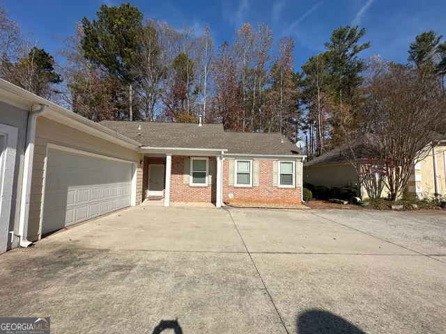 a kitchen with a refrigerator stove and wooden cabinets