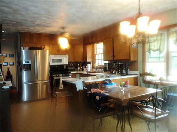 98 Long Road Fairhaven, MA 02719 - Photo 3 of 9 a kitchen with a dining table chairs refrigerator and sink