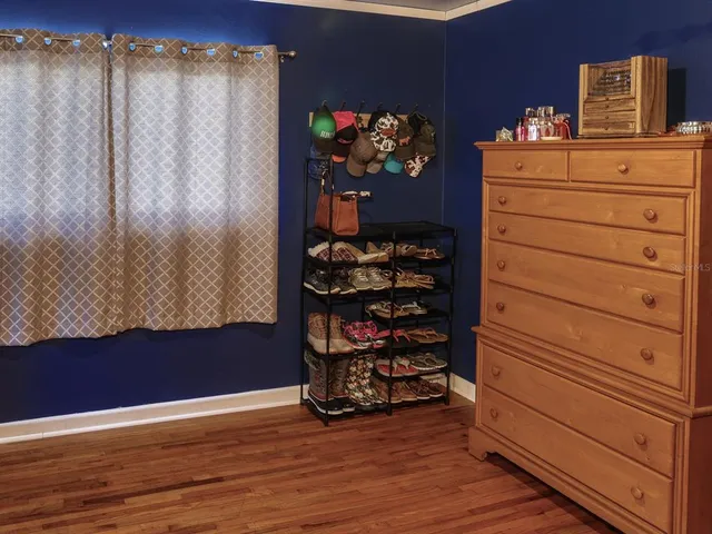 a bed sitting in a bedroom next to a window