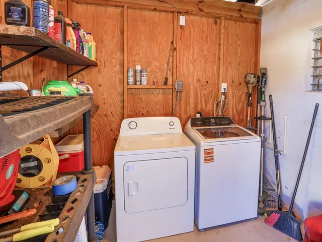 a view of a swimming pool with lawn chairs under an umbrella