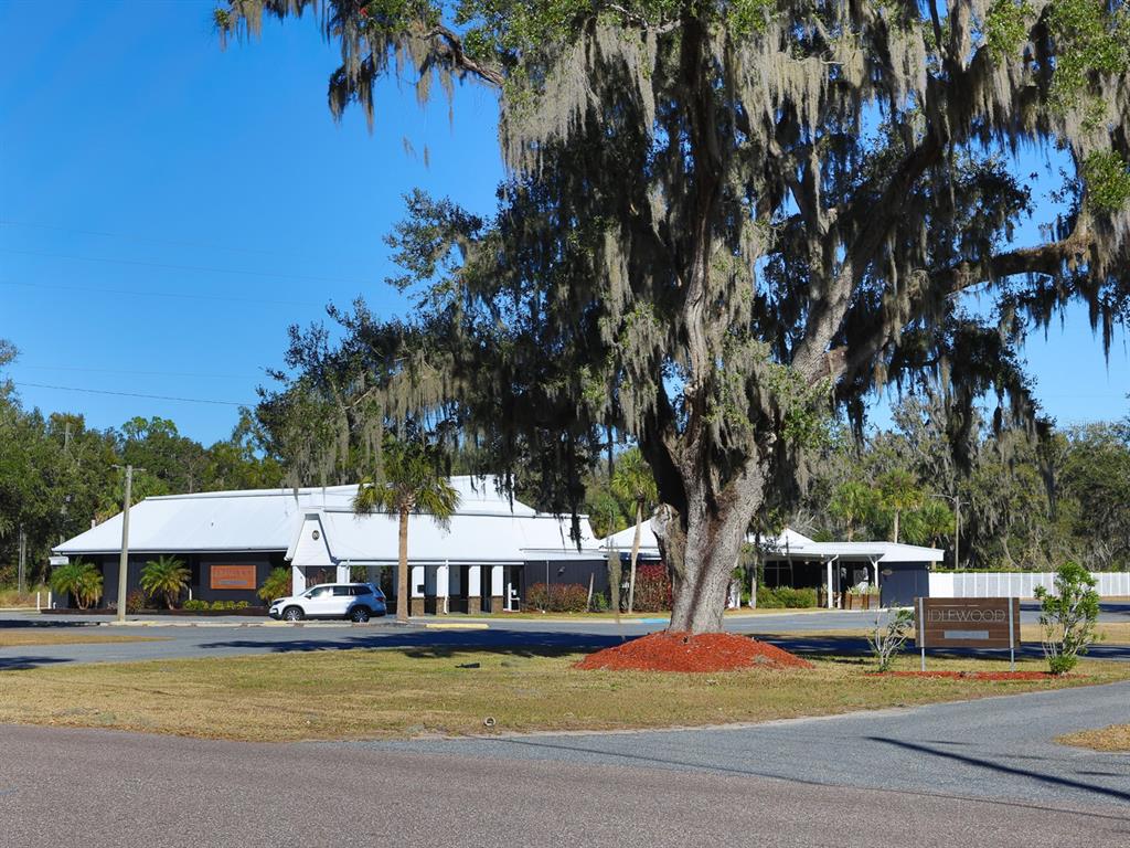 2140 East Main Street Bartow, FL 33830 - Photo 22 of 37 a view of a swimming pool with lawn chairs under an umbrella
