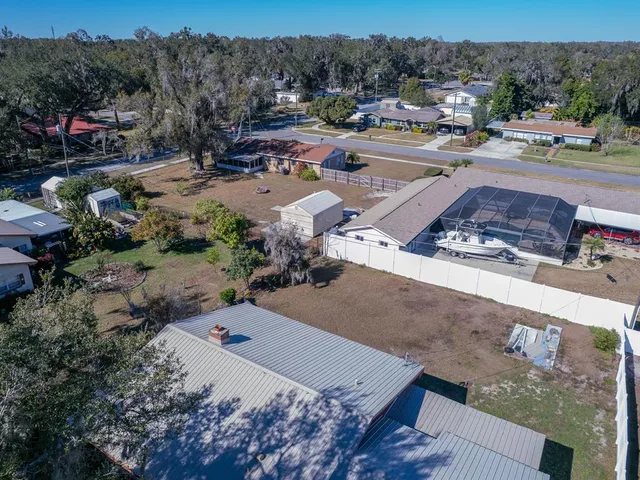 a view of a swimming pool with a yard and outdoor seating