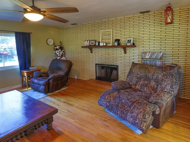 a living room with furniture rug and wooden floor